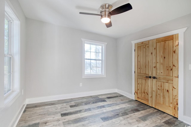 interior space with ceiling fan and wood-type flooring