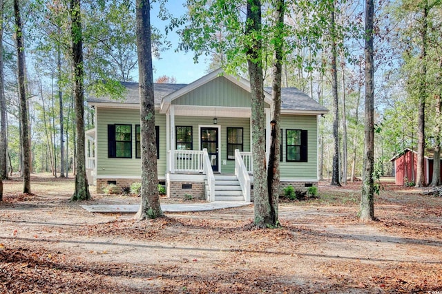 1409 Woodhaven Rd, Latta, SC 29565 - view of front of house featuring crawl space, covered porch, and a storage shed