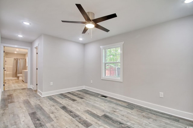 empty room with light hardwood / wood-style flooring and ceiling fan