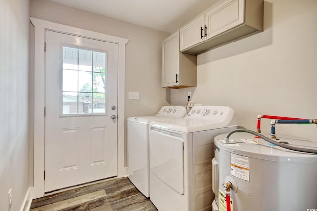 laundry room featuring cabinets, washer and clothes dryer, dark wood-type flooring, and water heater