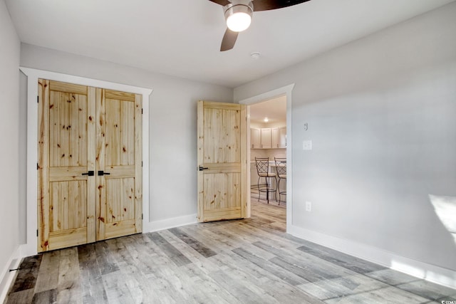 unfurnished bedroom with hardwood / wood-style floors and ceiling fan