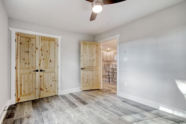 1409 Woodhaven Rd, Latta, SC 29565 - unfurnished bedroom with wood finished floors and a ceiling fan
