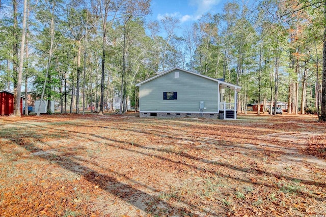 1409 Woodhaven Rd, Latta, SC 29565 - view of side of property with crawl space and a storage unit
