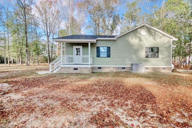 view of front of property featuring cooling unit and covered porch