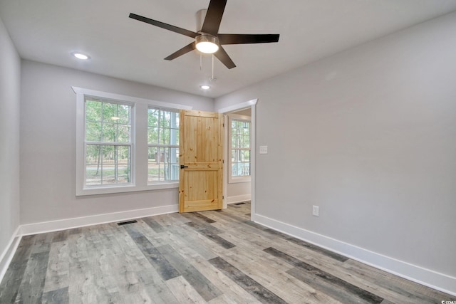 unfurnished room with hardwood / wood-style flooring and ceiling fan