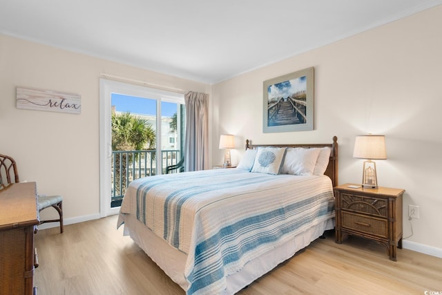 bedroom featuring access to exterior, light wood-type flooring, and ornamental molding