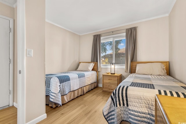 bedroom with light hardwood / wood-style floors and ornamental molding