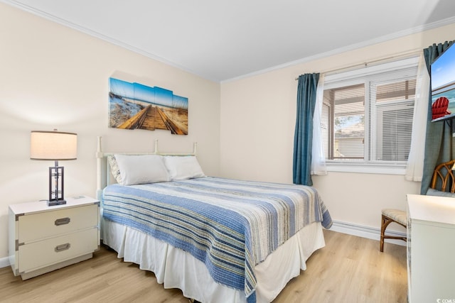 bedroom with crown molding, light hardwood / wood-style flooring, and a baseboard heating unit