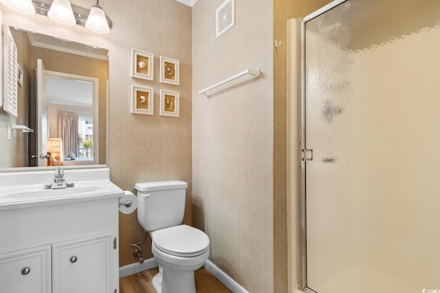 bathroom featuring hardwood / wood-style floors, vanity, toilet, and a shower with door