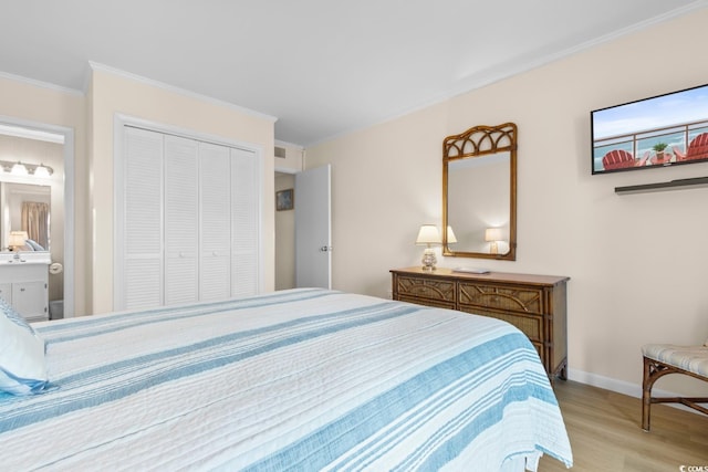 bedroom with a closet, ensuite bathroom, light hardwood / wood-style flooring, and ornamental molding