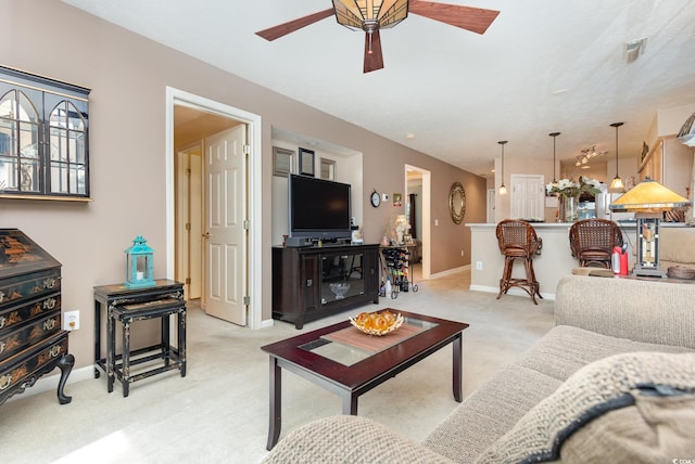 carpeted living room featuring ceiling fan