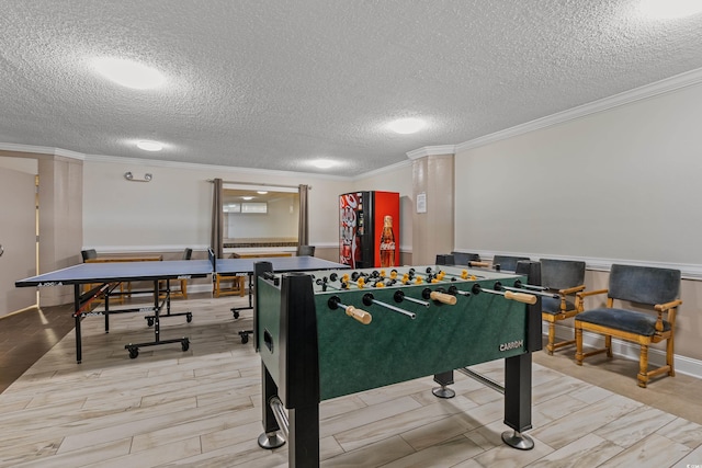 game room featuring crown molding and a textured ceiling