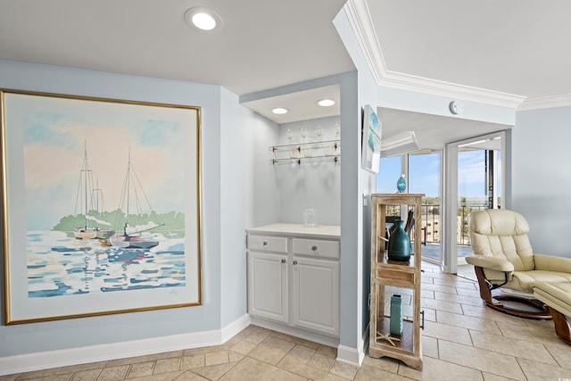 interior space with ornamental molding and light tile patterned floors