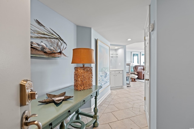 hall with light tile patterned floors