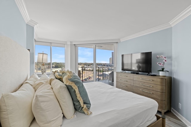 bedroom with expansive windows, ornamental molding, access to outside, and light hardwood / wood-style floors