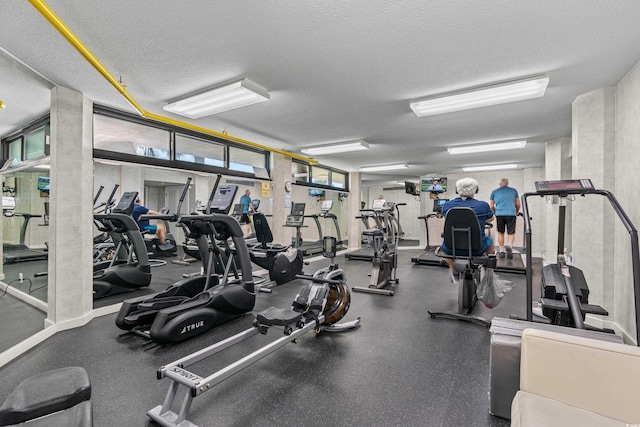 workout area featuring a textured ceiling