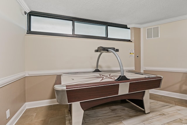 interior details featuring crown molding and a textured ceiling