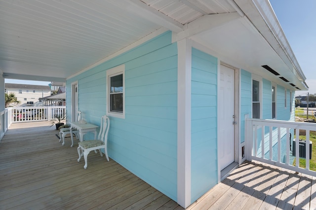 wooden terrace featuring covered porch