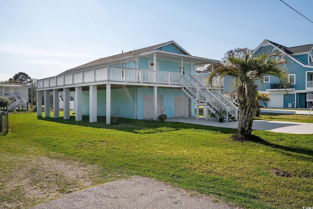 view of front of house featuring a garage, a front yard, and covered porch