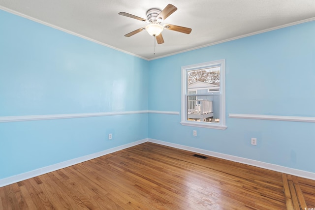 spare room featuring ceiling fan, crown molding, and hardwood / wood-style floors