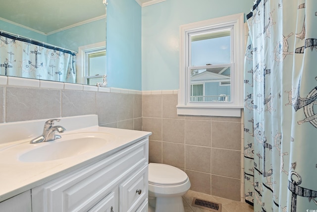 bathroom featuring toilet, vanity, tile walls, ornamental molding, and curtained shower