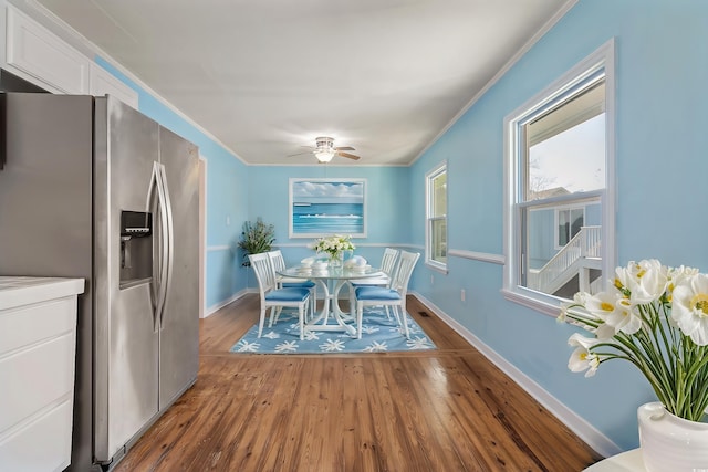 dining room with ceiling fan, crown molding, and hardwood / wood-style flooring