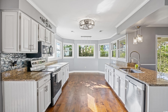 kitchen featuring sink, decorative light fixtures, dark hardwood / wood-style flooring, white cabinetry, and stainless steel appliances