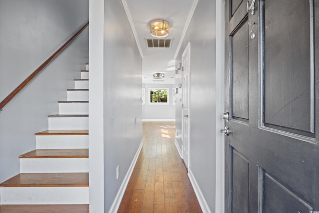 hall featuring hardwood / wood-style floors and ornamental molding