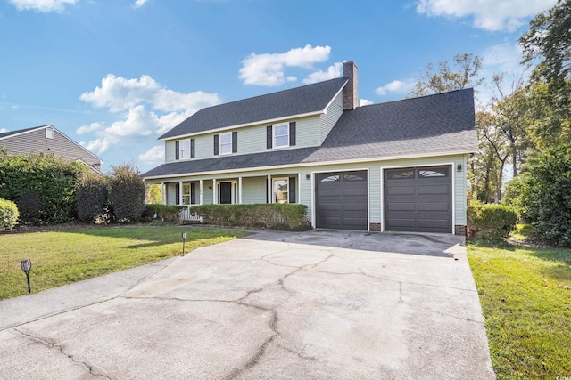 view of property featuring a garage and a front yard