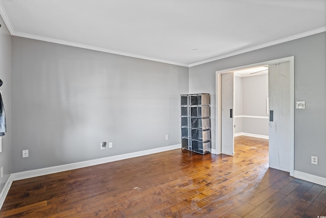 empty room with dark hardwood / wood-style flooring and crown molding