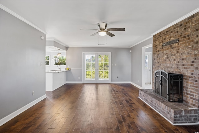 unfurnished living room featuring ceiling fan, french doors, dark hardwood / wood-style floors, a fireplace, and ornamental molding