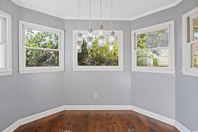 unfurnished room featuring ornamental molding, plenty of natural light, and dark wood-type flooring