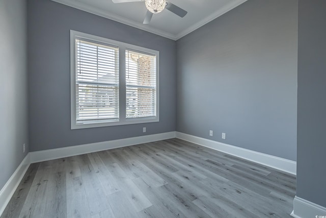 empty room featuring light hardwood / wood-style floors, ceiling fan, and crown molding