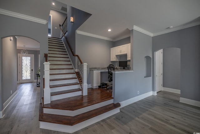 staircase featuring hardwood / wood-style flooring and ornamental molding