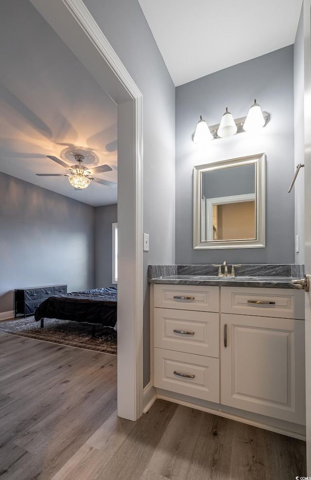 bathroom with ceiling fan, vanity, and hardwood / wood-style flooring