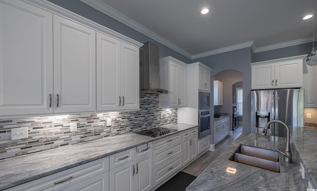 kitchen featuring white cabinetry, sink, wall chimney exhaust hood, and appliances with stainless steel finishes