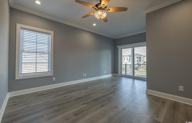 empty room with hardwood / wood-style flooring, ceiling fan, and crown molding