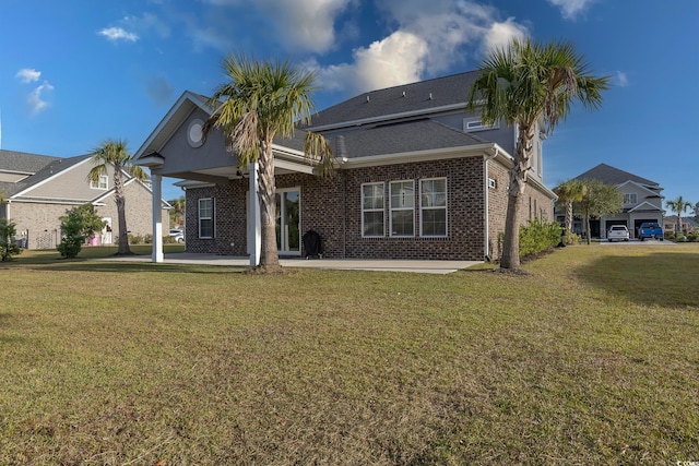 rear view of house featuring a yard