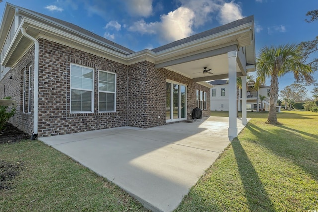 back of house featuring a patio area, ceiling fan, and a yard