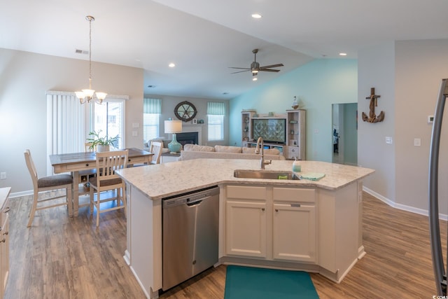 kitchen featuring white cabinets, a kitchen island with sink, sink, dishwasher, and lofted ceiling