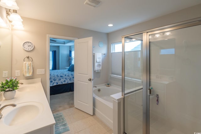 bathroom with tile patterned floors, vanity, and shower with separate bathtub