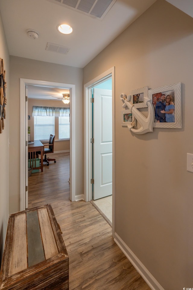 hallway with hardwood / wood-style floors