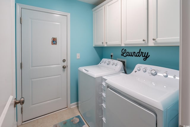 clothes washing area with cabinets, separate washer and dryer, and light tile patterned flooring