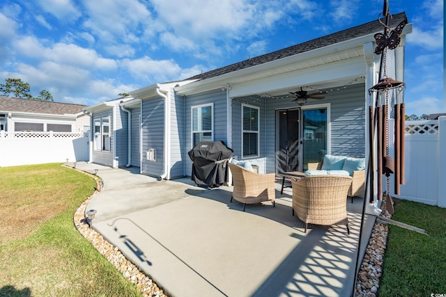 back of property featuring ceiling fan, a yard, and a patio