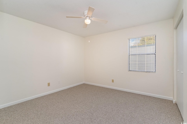 spare room featuring carpet floors and ceiling fan