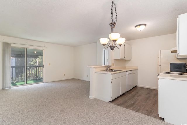 kitchen featuring sink, white dishwasher, decorative light fixtures, white cabinets, and hardwood / wood-style flooring