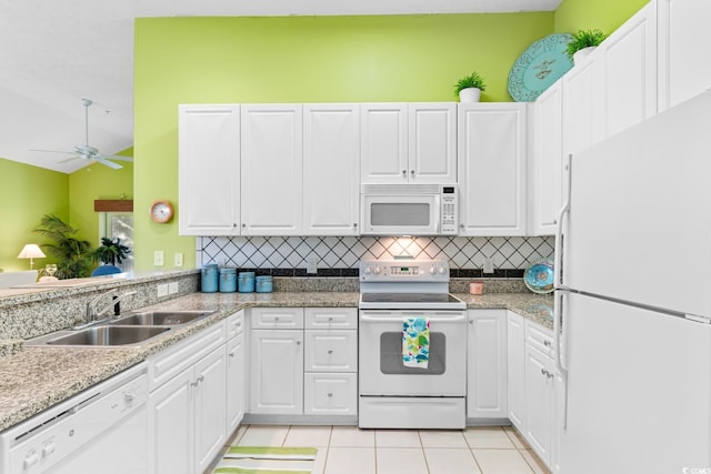 kitchen with ceiling fan, sink, lofted ceiling, white appliances, and white cabinets