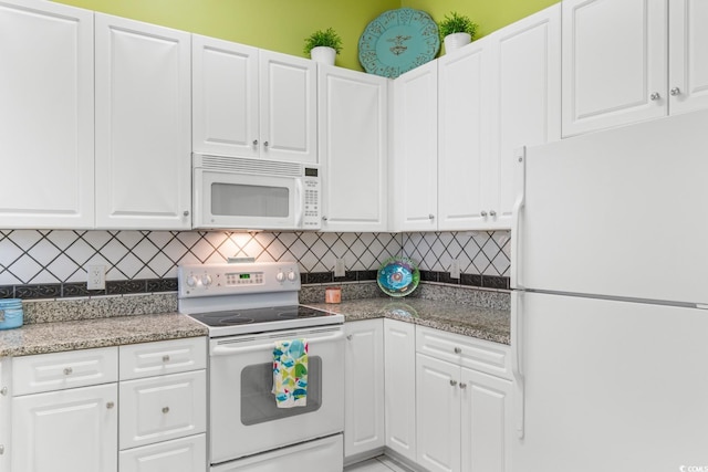 kitchen with decorative backsplash, white cabinetry, white appliances, and dark stone counters