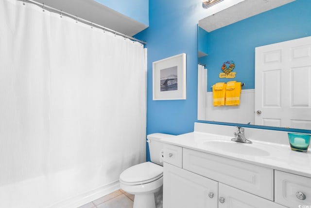 bathroom featuring toilet, vanity, and tile patterned floors