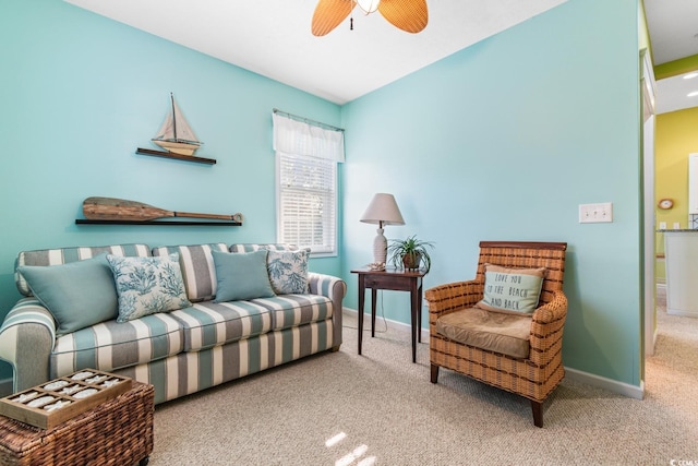 carpeted living room with ceiling fan